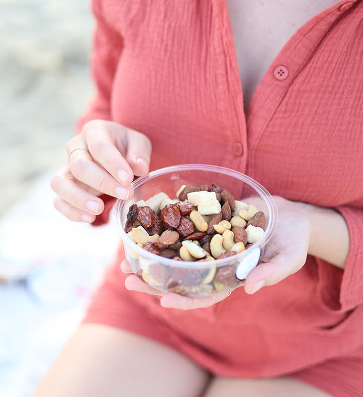 a person holding a bowl of nuts